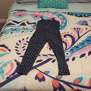 A jean romper with ruffles on the ankles and hips